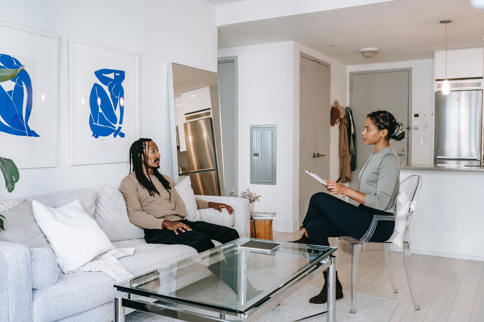 black man visiting female psychologist in modern office