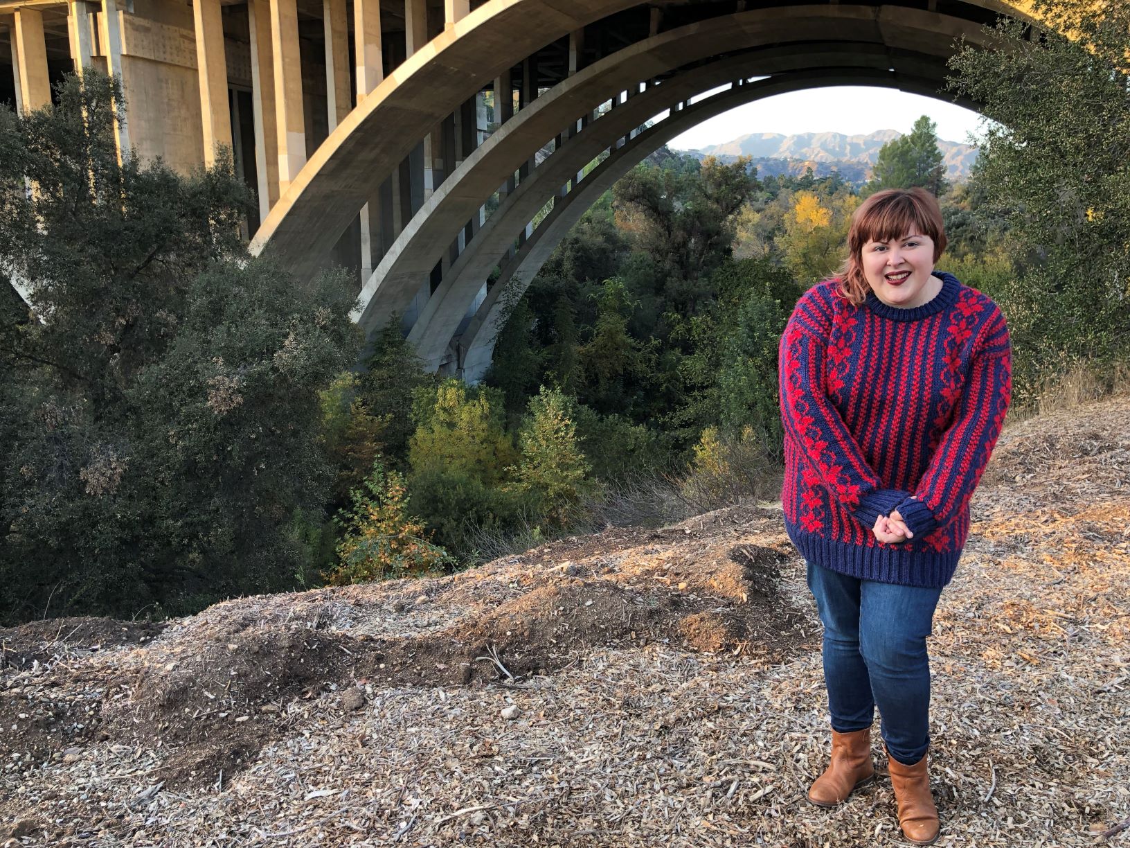 woman outdoors near a bridge