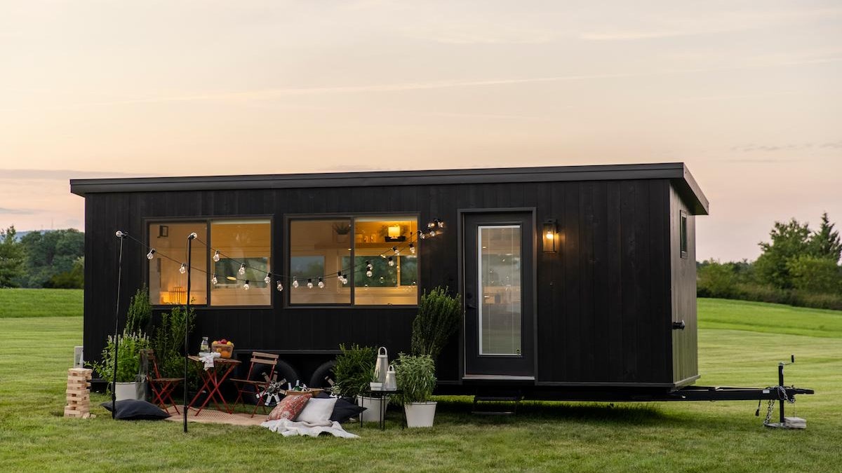a tiny home in a field at sunset