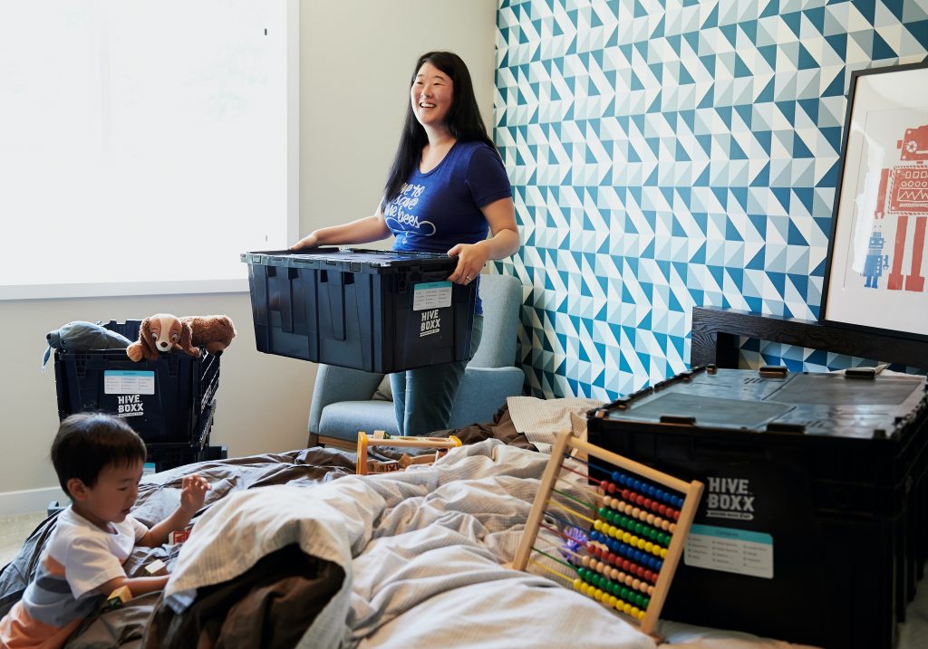 woman and child packing bedroom to move