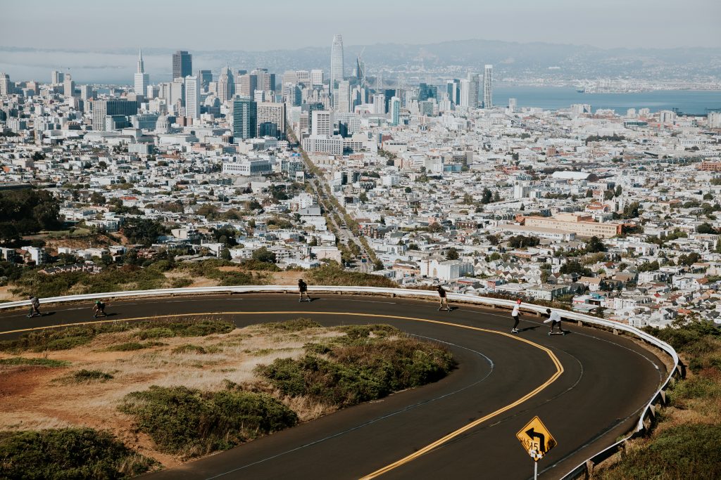 photo of people boarding down road