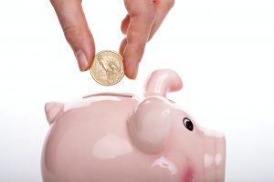 silver round coin on white ceramic pig coin bank
