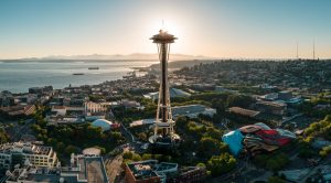 The Seattle Space Needle against Elliot Bay. Olympic National Park can be seen in the distance. This photo authorized via LAANC link to air traffic control, and operated under the FAA's Part 107 licensure.